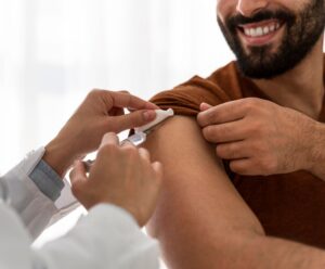 A foto mostra rapaz sendo vacinado contra gripe