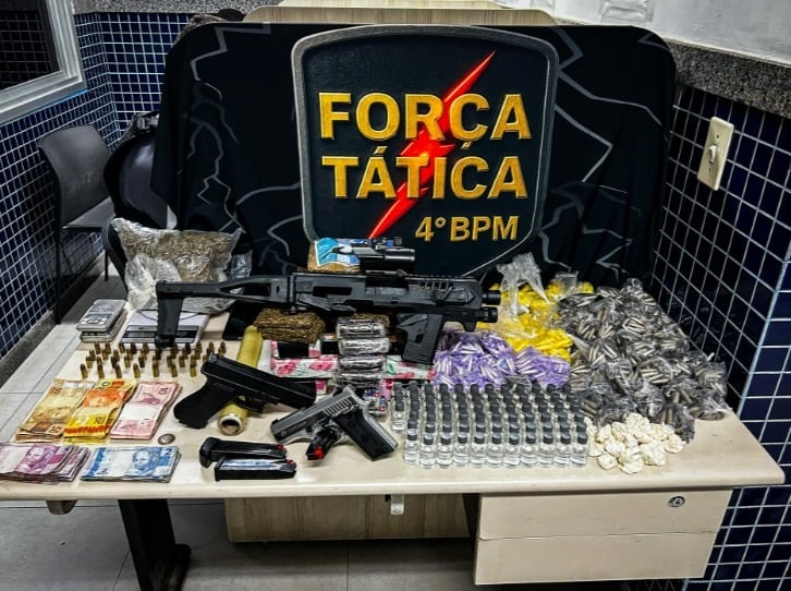 Foto retrata mesa com drogas e armas apreendidas pela Polícia Militar.